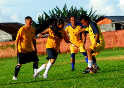 US Navy 100715-N-4044H-500 U.S. Navy Sailors and Indonesian soccer players compete for control at a soccer match in Indonesia