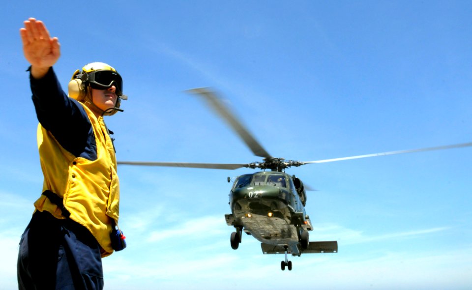 US Navy 100719-N-1675O-213 Culinary Specialist 3rd Class Drew Iverson launches an SH-60F Sea Hawk helicopter from the U.S. 7th Fleet command ship USS Blue Ridge (LCC 19)