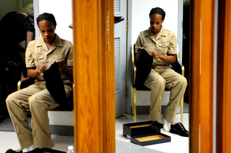 US Navy 100719-N-4930E-310 Navy Reserve Sailor of the Year Hospital Corpsman 1st Class Shalanda Brewer inspects new uniform shoes at the Navy Annex