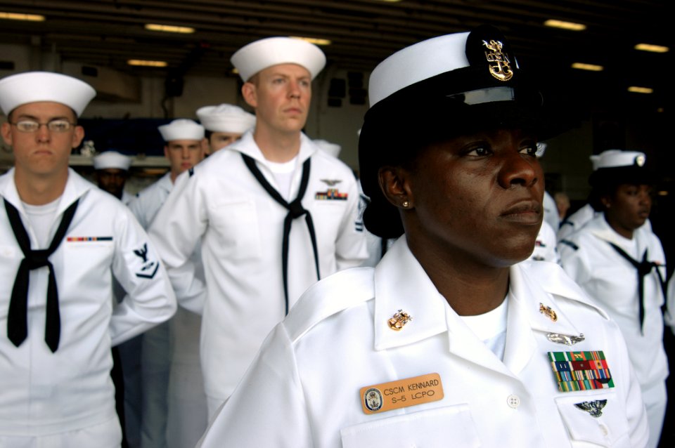 US Navy 100715-N-1281L-133 Master Chief Culinary Specialist Marilyn Kennard leads the honor platoon during a burial at sea aboard the amphibious assault ship USS Makin Island (LHD 8)