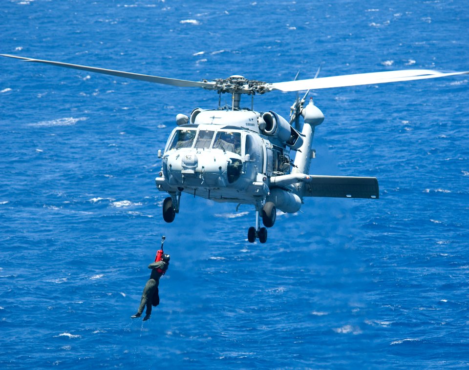 US Navy 100719-N-6720T-104 Explosive Ordnance Disposal Technician 2nd Class Jonathan Tatman is hoisted by an HH-60H Sea Hawk helicopter during cast and recovery training