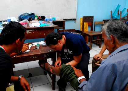 US Navy 100715-N-4044H-179 Project HOPE volunteer medical professional Dr. April Kranz examines a patient's leg during a Pacific Partnership 2010 medical civic action program