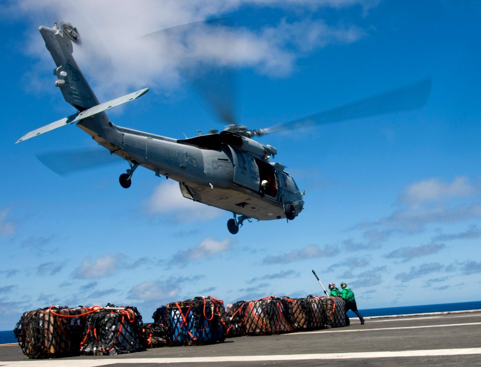 US Navy 100715-N-4830B-098 Sailors prepare to attach cargo to an MH-60S Sea Hawk helicopter