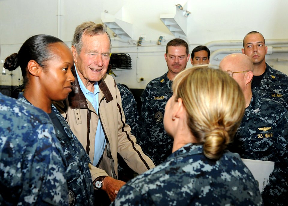 US Navy 100715-N-8689C-192 Former President George H.W. Bush speaks to Individual Augmentee Sailors during a visit aboard the aircraft carrier