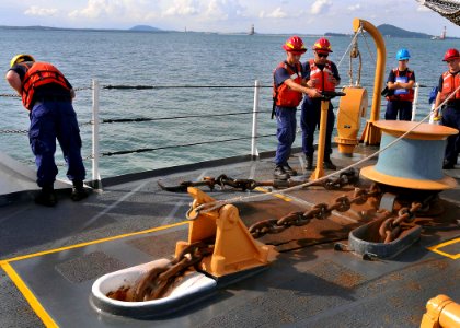 US Navy 100715-N-7643B-086 U.S. Coast Guard Damage Controlman 2nd Class Bryan Norris, center, controls the anchor windless as the U.S. Coast Guard cutter Mellon