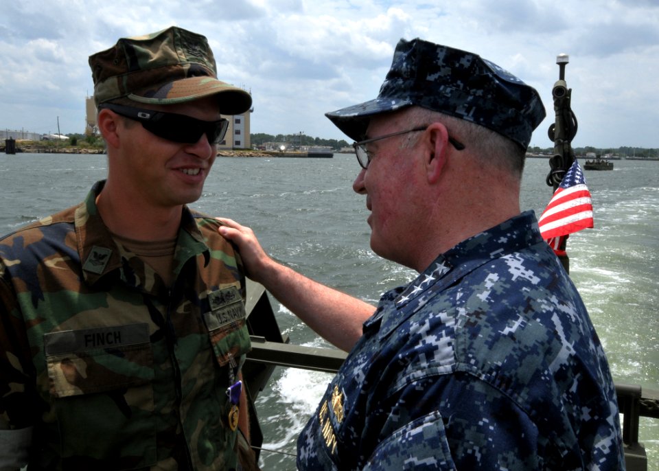 US Navy 100719-N-9095H-029 Adm. J.C. Harvey Jr., commander of U.S. Fleet Forces Command, speaks with Gunner's Mate 2nd Class Michael Finch, left, assigned to Riverine Squadron (RIVRON) 1,