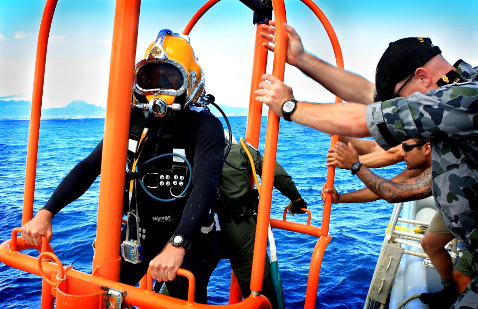 US Navy 100719-O-5986R-150 Able Seaman Clearance Diver Thomas Buchanan, assigned to Australian navy Clearance Diving Team 1, is lowered into the water during Rim of the Pacific (RIMPAC) 2010