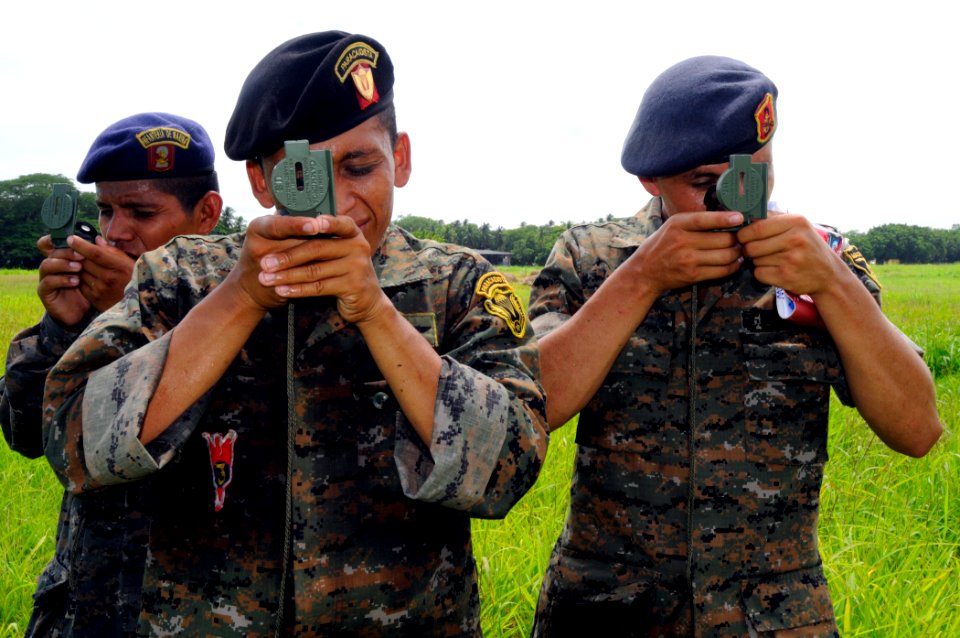 US Navy 100716-N-9643W-596 Guatemalan marines use compasses to find pre-determined points in a field during the Marine Corps subject matter expert exchange