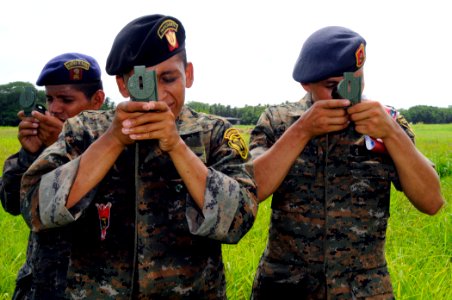 US Navy 100716-N-9643W-596 Guatemalan marines use compasses to find pre-determined points in a field during the Marine Corps subject matter expert exchange