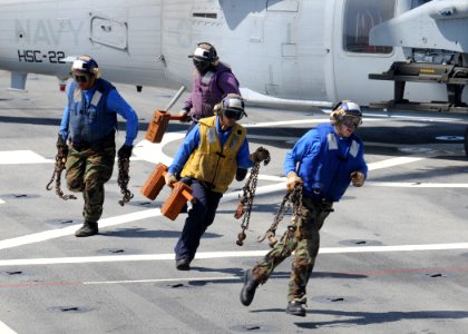 US Navy 100720-N-3154P-017 Sailors remove the chocks and chains from an MH-60S Sea Hawk helicopter assigned to Helicopter Sea Combat Squadron (HSC) 22 aboard the amphibious transport dock ship USS Ponce (LPD 15)