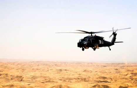 US Navy 100719-N-7130B-022 An Army MH-60L Black Hawk helicopter transports Iraqi Special Operations Forces and Soldiers and Soldiers across the deserts of Northern Iraqi photo
