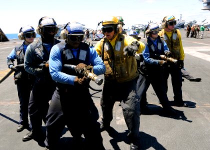 US Navy 100720-N-6935K-003 Sailors simulate fighting a fire during a fire drill aboard the Nimtiz-class aircraft carrier USS Dwight D. Eisenhower (CVN 69)