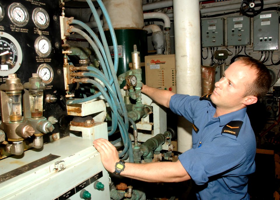 US Navy 100718-N-0000H-033 Able Seaman Daniel Graham, from Abbotsford, British Columbia, a marine engineer mechanic aboard the Canadian navy multi-role patrol frigate HMCS Calgary monitors the ship's reverse osmosis desalinatio