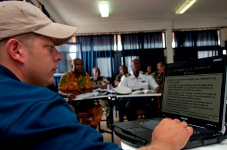 US Navy 100720-N-9589S-432 Master-at-Arms 2nd Class John Curry of Maritime Civil Affairs Security Training, Security Forces Assistance team, guides members of the Cameroon navy through a French version of an electronic presenta photo