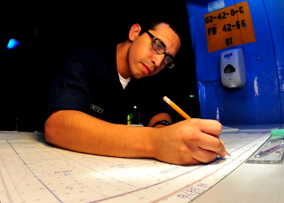 US Navy 100721-N-0569K-047 Operations Specialist Seaman Alcides J. Fuentes plots the position of USS Enterprise (CVN 65)