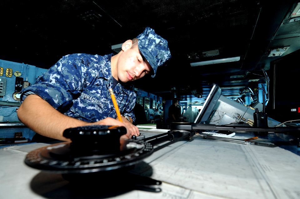US Navy 100717-N-7191M-031 Quartermaster Seaman Apprentice Joel Serra Galindo, from Brandon, Fla., plots a navigation chart on the navigation bridge aboard the aircraft carrier USS George Washington (CVN 73)
