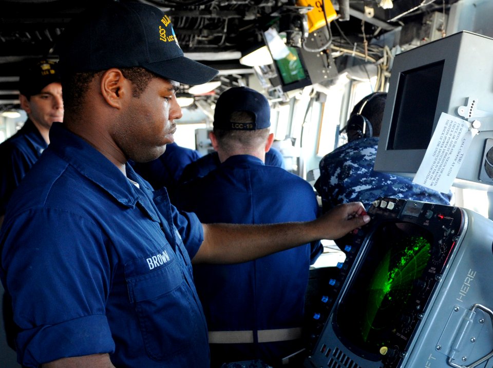 US Navy 100719-N-0864H-349 Operations Specialist Seaman Chazz Brown reads the radar aboard the U.S. 7th Fleet command ship USS Blue Ridge (LCC 19)