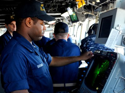 US Navy 100719-N-0864H-349 Operations Specialist Seaman Chazz Brown reads the radar aboard the U.S. 7th Fleet command ship USS Blue Ridge (LCC 19)
