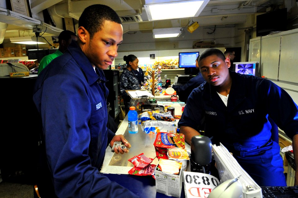 US Navy 100721-N-2953W-383 Ship's Serviceman Seaman Recruit Preston Hornes helps a customer in the ship's store aboard USS Carl Vinson (CVN 70)