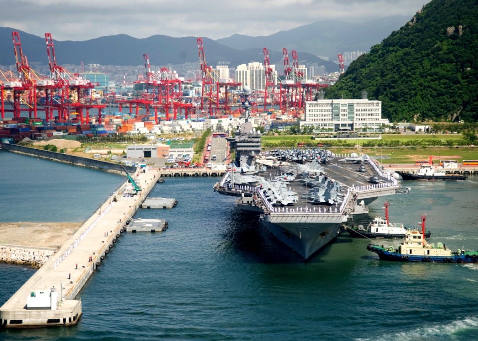US Navy 100721-N-2013O-422 Tugboats move the aircraft carrier USS George Washington (CVN 73) to a pier in Busan, Republic of Korea