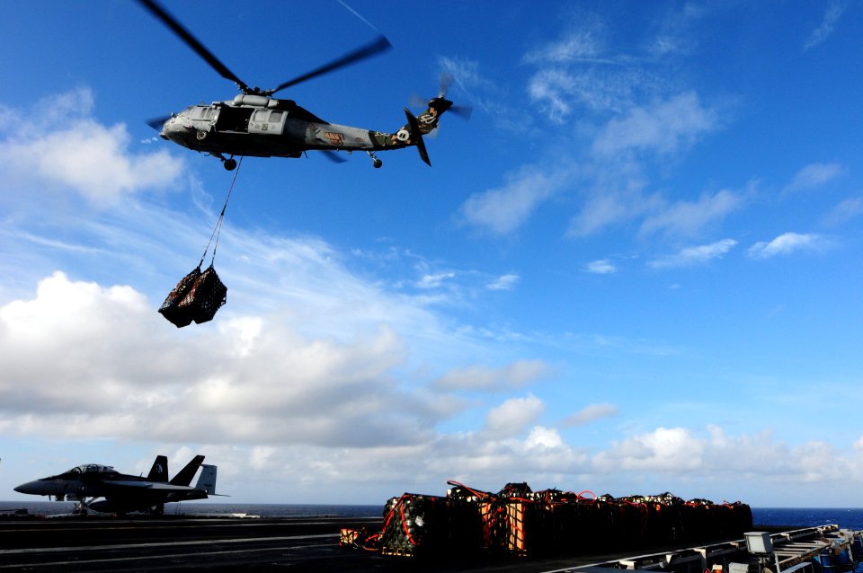 US Navy 100721-N-3659B-087 An MH-60S Sea Hawk helicopter delivers cargo to USS Ronald Reagan (CVN 76)