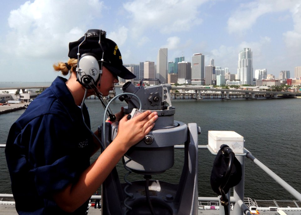 US Navy 100721-N-3265K-066 Quartermaster Seaman Apprentice Katie A. Seavey uses a telescopic alidade to find navigation aides while pulling away from the port of Miami aboard the multi-purpose amphibious assault ship USS IWO JI