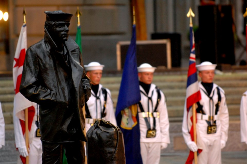 US Navy 100720-N-4930E-521 Members of the U.S. Navy ceremonial color guard take formation behind a tribute to the Lone Sailor before the Navy Band performs at the Navy Memorial in Washington, D.C