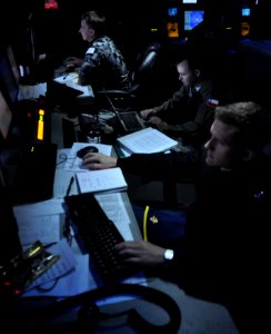 US Navy 100719-N-7042V-107 Royal Australian Navy Leading Seaman Livingston Harrison, foreground, U.S. Navy Lt. j.g. Joe Spence and Columbian navy Lt. Cmdr. Anibal Limbo stand watch in Sea Combat Control a