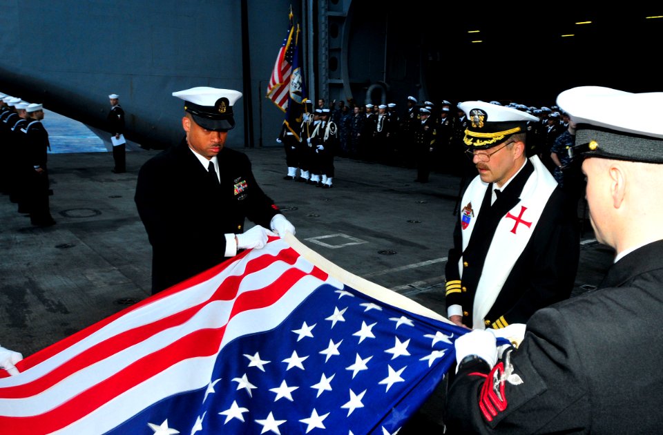 US Navy 100721-N-3595W-002 Cmdr. Jon Brzek and Sailors participate in a sunrise burial at sea aboard USS Dwight D. Eisenhower (CVN 69)
