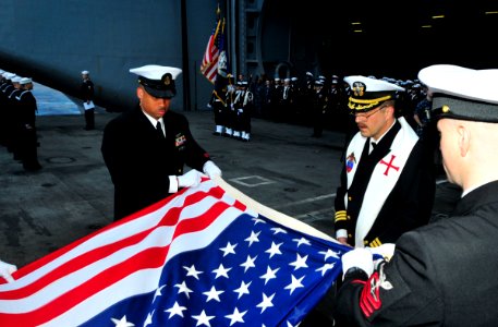 US Navy 100721-N-3595W-002 Cmdr. Jon Brzek and Sailors participate in a sunrise burial at sea aboard USS Dwight D. Eisenhower (CVN 69) photo