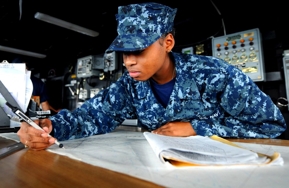 US Navy 100720-N-7948R-017 Quartermaster Seaman Chantrel Corbin plots a fix on a chart of the Arabian Sea aboard USS Pearl Harbor (LSD 52)