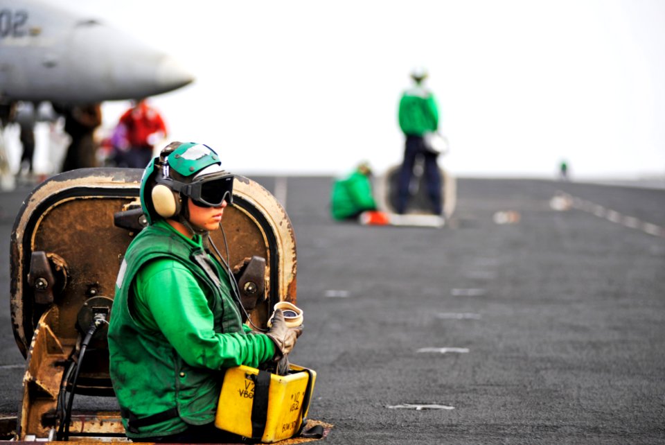 US Navy 100721-N-6003P-084 Aviation Boatswain's Mate (Equipment) Airman Kayla Gillock waits to raise the jet blast deflector aboard USS Harry S. Truman (CVN 75)