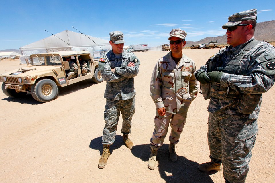 US Navy 100721-N-8863V-494 Capt. Jay Kadowaki, center, commanding officer of the Naval Surface Warfare Center, Corona Division, listens as Maj. Brian Murphy, the brigade command intelligence trainer, speaks during Kadowaki's v