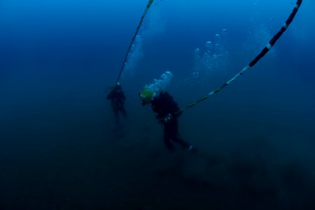 US Navy 100722-N-1134I-252 Navy Diver 2nd Class Troy Crowder and a Mexican navy diver take strain on their dive umbilicals during a salvage recovery exercise