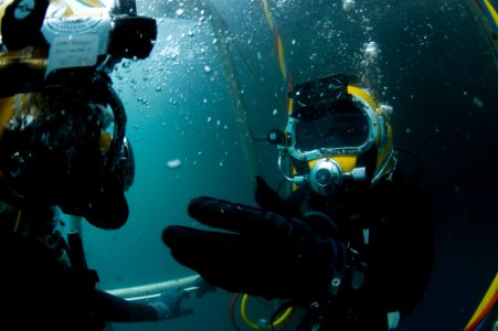 US Navy 100722-N-1134I-063 Navy Diver 2nd Class Troy Crowder uses hand signals to communicate with a Mexican navy diver during a salvage recovery exercise
