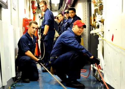 US Navy 100721-N-1287L-025 The at-sea fire party aboard USS Enterprise (CVN 65) assists in line handling procedures
