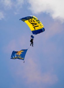 US Navy 100720-N-5366K-118 Chief Special Warfare Operator (SEAL) Justin Gauny flies with a Navy SEAL trident flag during the opening ceremony of a St. Paul Saints baseball game at Midway Stadium photo