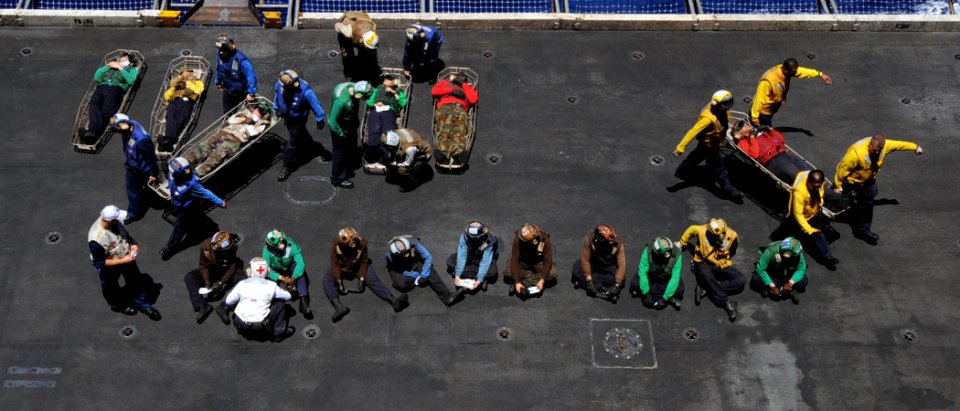 US Navy 100720-N-6935K-004 Sailors carry off and treat simulated casualties during a mass casualty drill aboard the Nimtiz-class aircraft carrier USS Dwight D. Eisenhower (CVN 69)