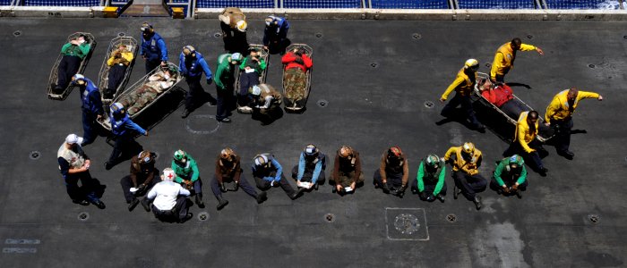 US Navy 100720-N-6935K-004 Sailors carry off and treat simulated casualties during a mass casualty drill aboard the Nimtiz-class aircraft carrier USS Dwight D. Eisenhower (CVN 69)