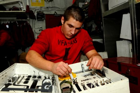 US Navy 100723-N-1092P-032 Aviation Ordnanceman Airman James Phillips epaints the outlines of tools on the inside of a gun box aboard USS Harry S. Truman (CVN 75)