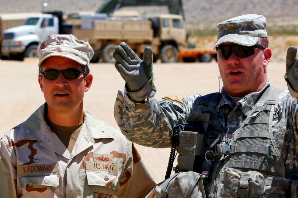 US Navy 100721-N-8863V-472 Capt. Jay Kadowaki, left, commanding officer of the Naval Surface Warfare Center, Corona Division, listens as Maj. Brian Murphy, the brigade command intelligence trainer, speaks during Kadowaki's visi