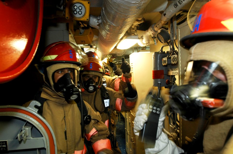 US Navy 100723-N-6477M-034 ailors stand by to enter Main Engine Room 2 during a main space fire drill aboard the amphibious transport dock ship USS Cleveland (LPD 7)