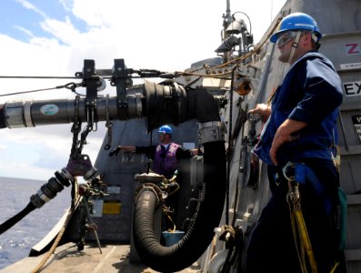 US Navy 100720-N-7058E-195 Engineman 1st Class Christopher Richars, left, and Information Systems Technician 1st Class Kendal Nichols look on as the littoral combat ship USS Freedom (LCS 1) receives fuel