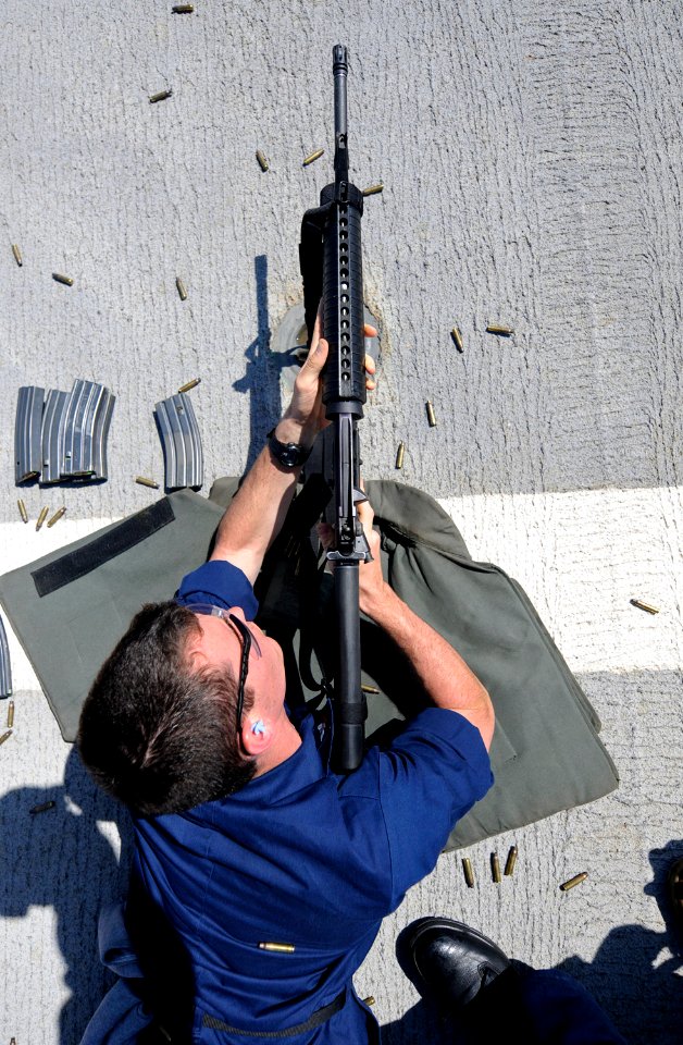 US Navy 100723-N-7280V-350 Information Systems Technician 3rd Class Michael Woods fires an M-16 rifle during a weapons qualification shoot aboard the U.S. 7th Fleet command ship USS Blue Ridge (LCC 19)