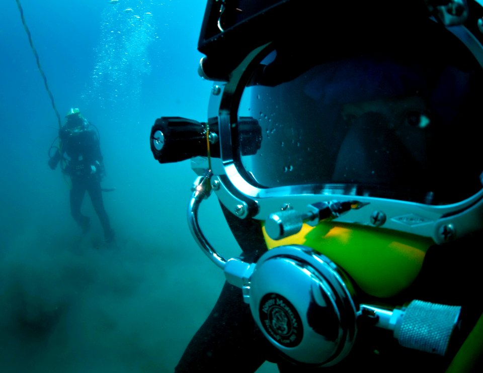 US Navy 100722-N-1134L-355 Navy Diver 2nd Class Troy Crowder, assigned to Company 2-6 of Mobile Diving and Salvage Unit (MDSU) 2, and a Mexican navy diver search the sea floor during a salvage recovery exercise