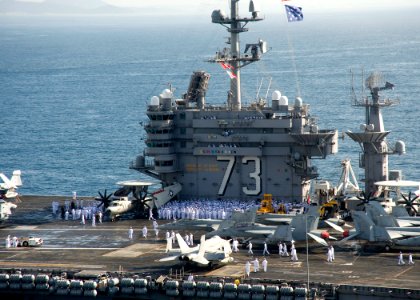 US Navy 100721-N-2013O-027 Sailors muster on the flight deck before manning the rails as the aircraft carrier USS George Washington (CVN 73) arrives in Busan, Republic of Korea