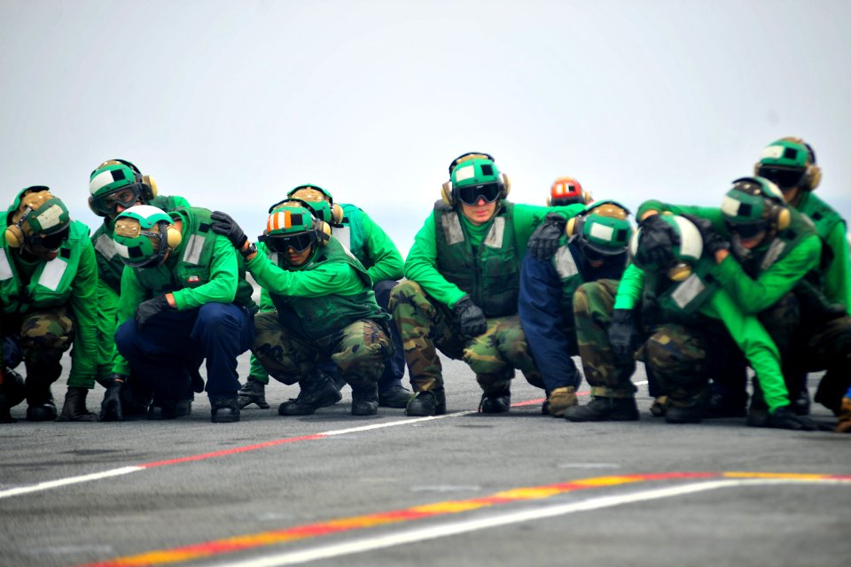 US Navy 100721-N-2953W-955 Sailors brace for shock on the ship's flight deck during a general quarters drill aboard USS Carl Vinson (CVN 70)