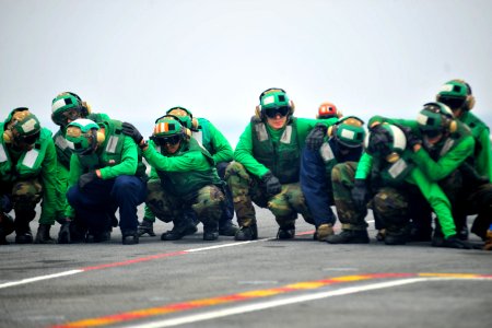 US Navy 100721-N-2953W-955 Sailors brace for shock on the ship's flight deck during a general quarters drill aboard USS Carl Vinson (CVN 70)