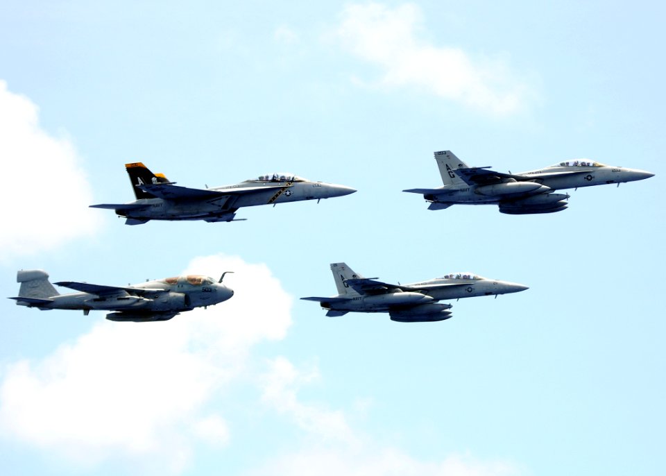 US Navy 100724-N-4236E-817 Three F-A-18F Super Hornets assigned to the Jolly Rogers of Strike Fighter Squadron (VFA) 103 and an EA-6B Prowler assigned to the Patriots of Electronic Attack Squadron (VAQ) 140