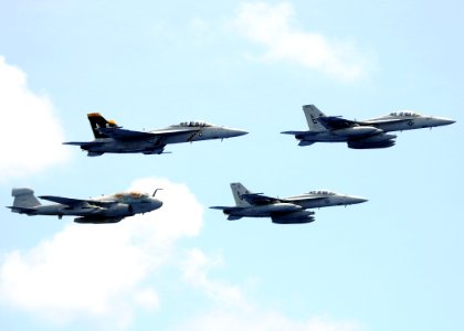 US Navy 100724-N-4236E-817 Three F-A-18F Super Hornets assigned to the Jolly Rogers of Strike Fighter Squadron (VFA) 103 and an EA-6B Prowler assigned to the Patriots of Electronic Attack Squadron (VAQ) 140